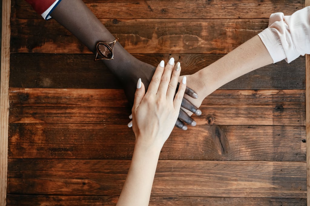 Three diverse hands stacked together symbolising unity and diversity. Picture: Alexander Suhorucov, Pexels
