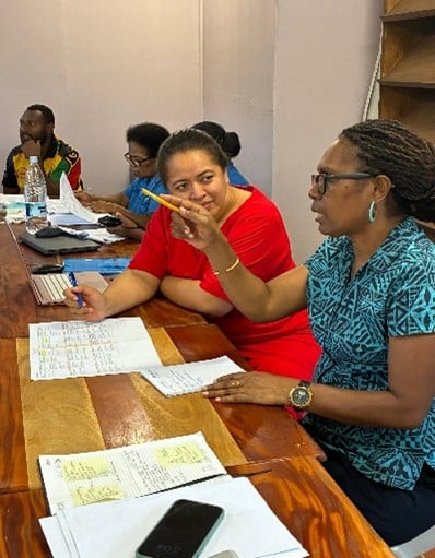 Workshop participants from Vanuatu and Tonga in discussion during a group activity.