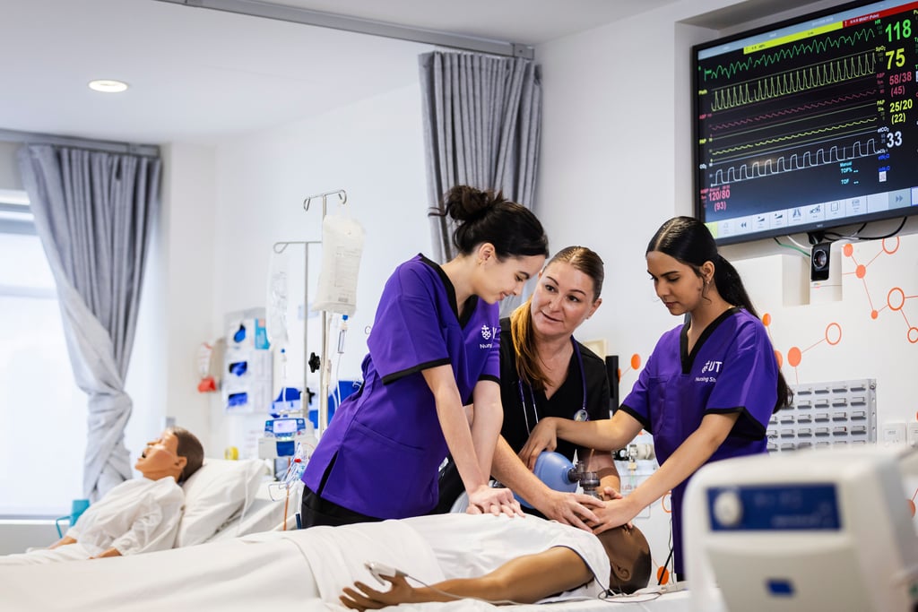 Bachelor of Nursing student in clinical labs simulating patient care with a student.