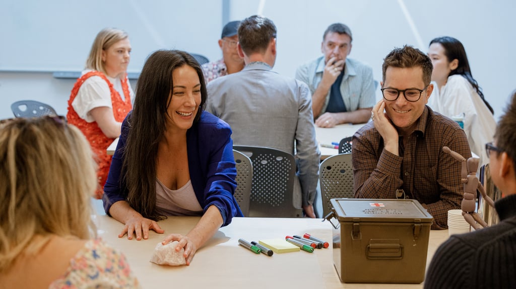 A group of people do an activity at a table