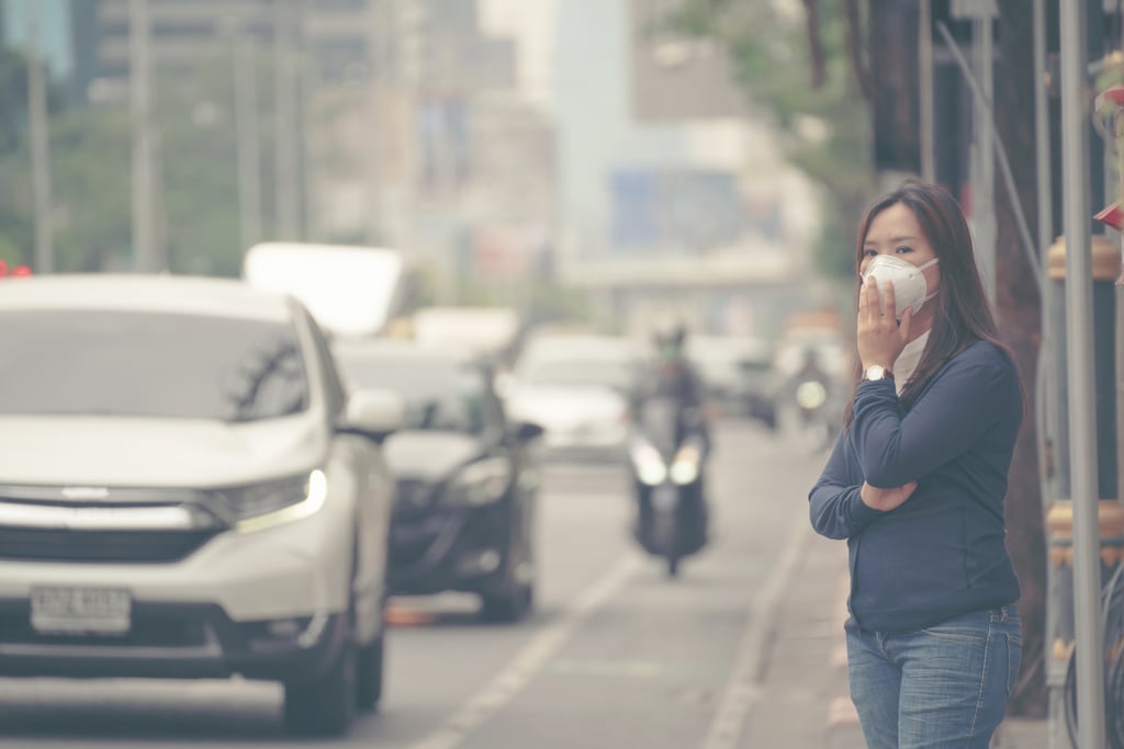 Woman wearing protective mask in the city street.