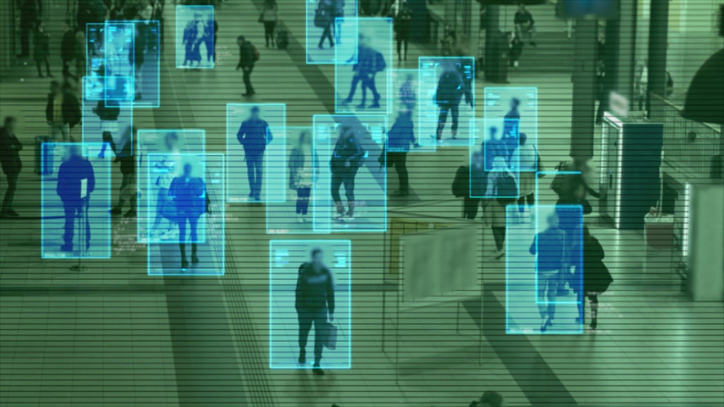Scanning a crowd of people walking at a railway station. Surveillance interface using artificial intelligence and facial recognition. Picture: Adobe Stock