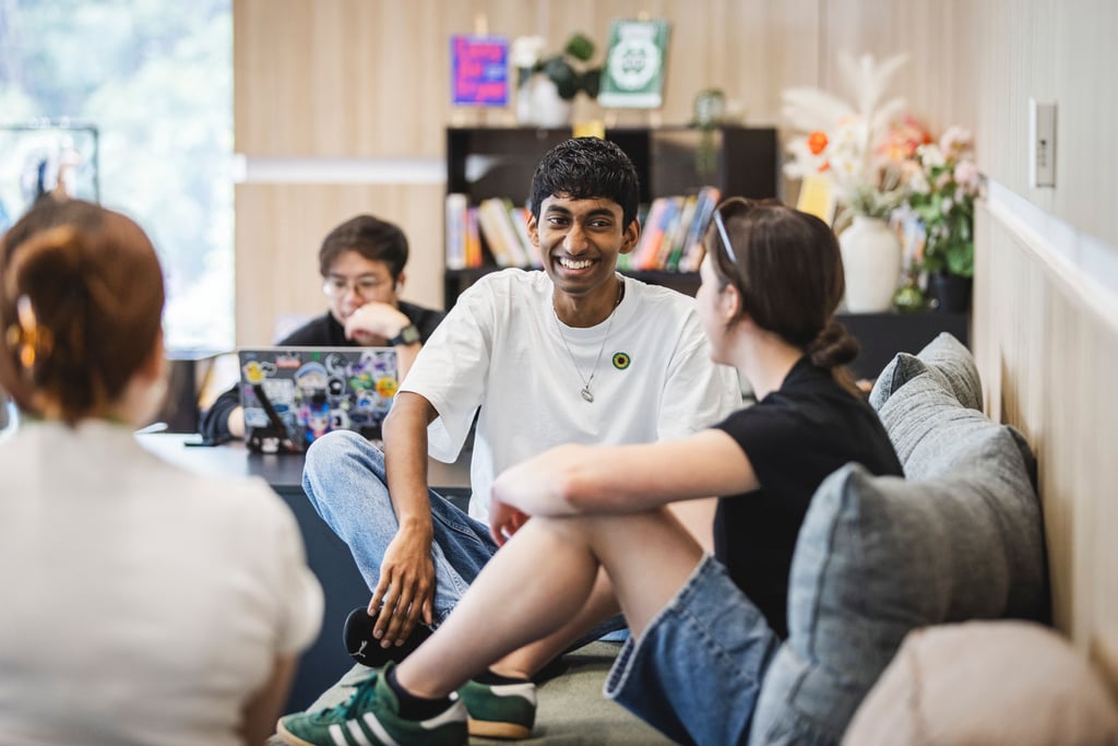 Students sit on a lounge in the wellbeing space