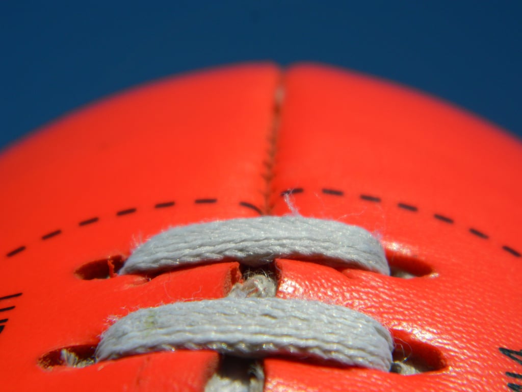 Close up of an Australian rules football on a blue sky background. Picture by Michael/Adobe Stock
