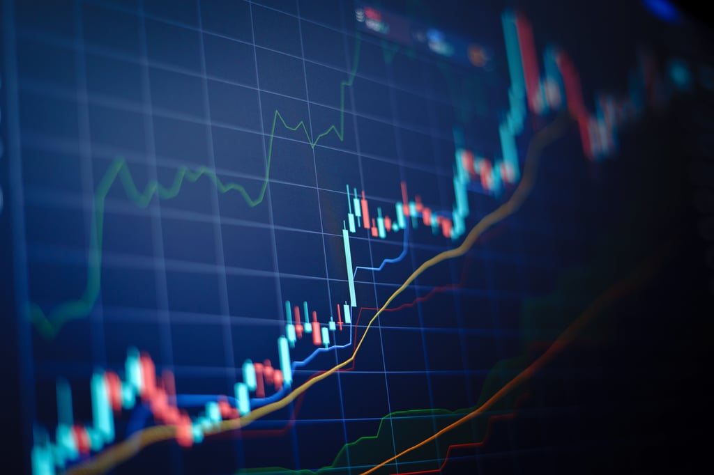 Closeup financial chart with uptrend line candlestick graph in stock market on blue colour monitor background.