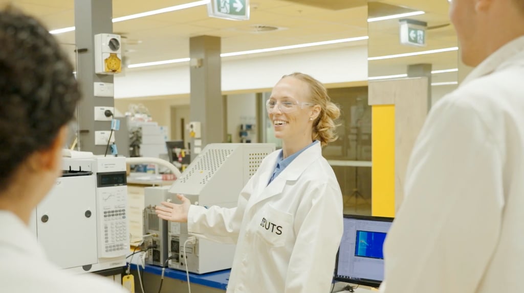 Dr Maiken Ueland sitting at a desk in a lab