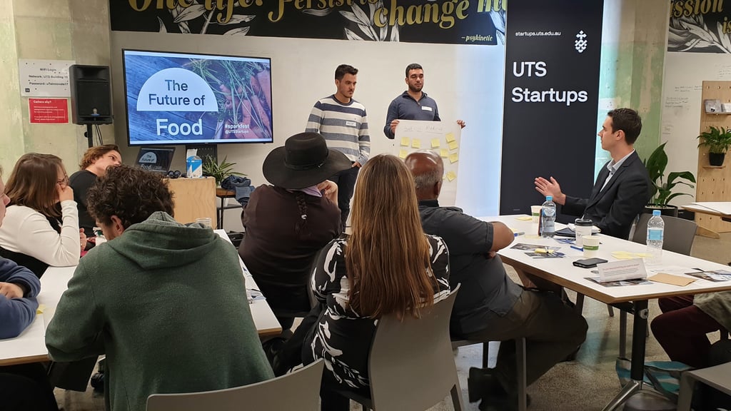 Students presenting ideas at a UTS Startups event