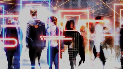 People walking through a brightly lit digital environment overlaid with colourful geometric lines and network patterns.
