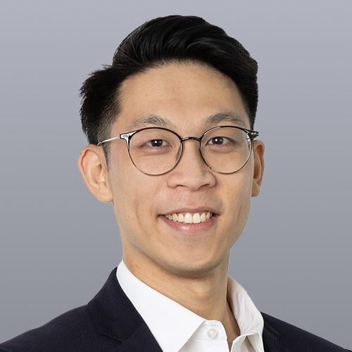 Ethan Huang wears a white shirt and a black suit