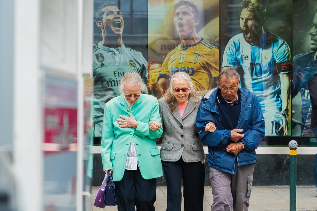 Group of smiling older people in a huddle.