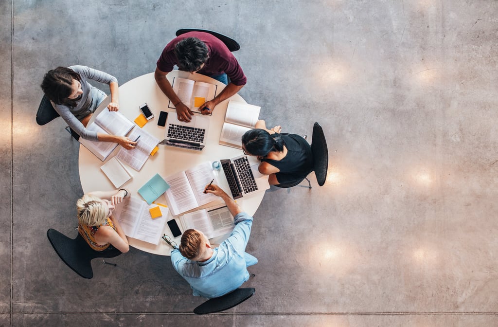 Top view of group of people sitting together at table