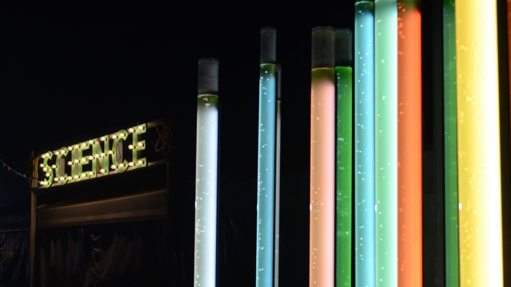 Coloured tubes with the word science in the background.