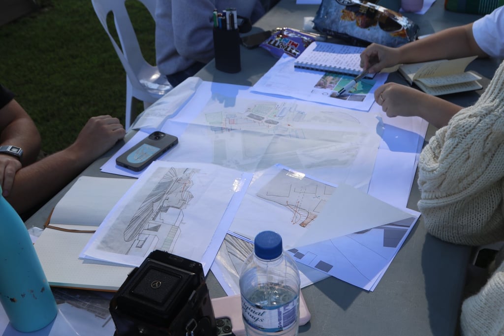 Architectural designs scattered on a table.
