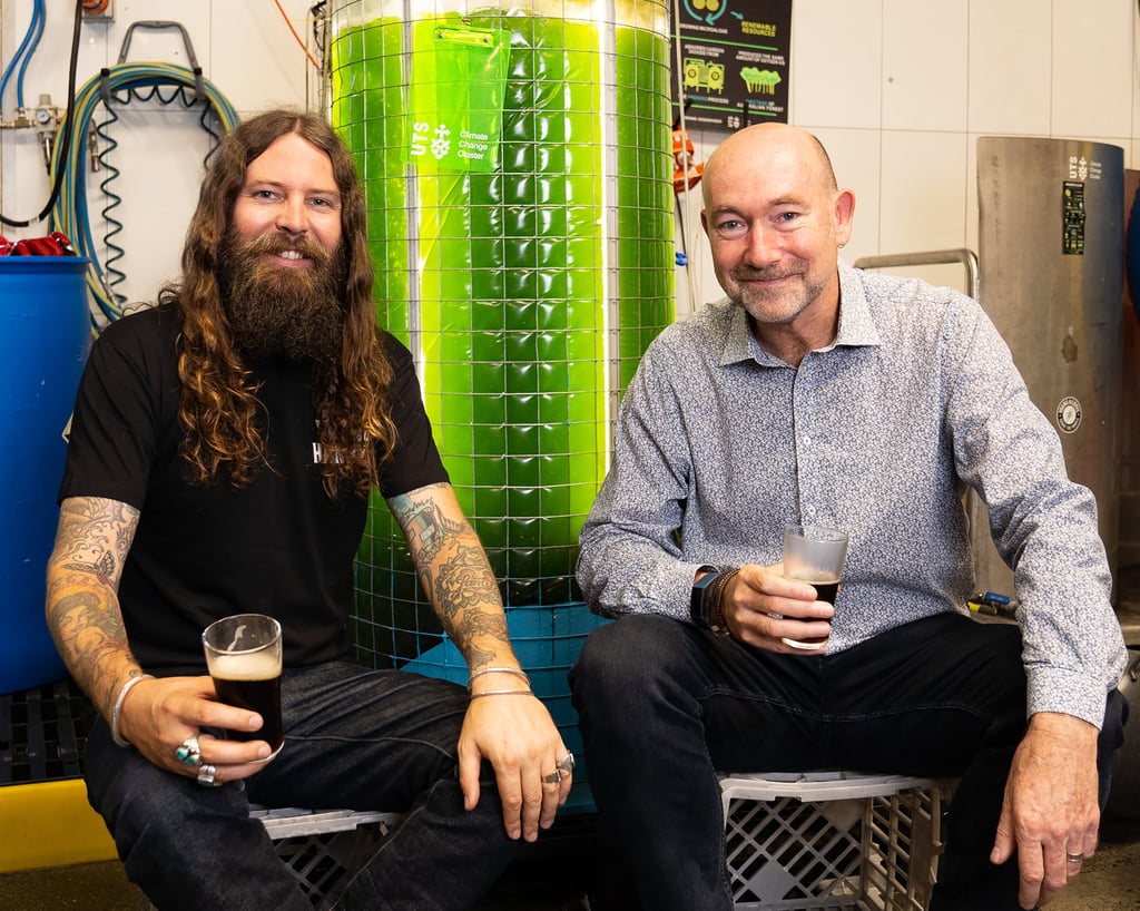 Photo of Professor Peter Ralph and Oscar McMahon with an algae bioreactor