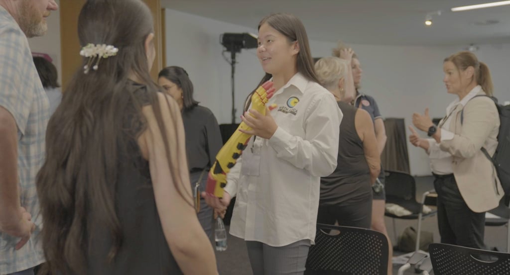 UTS Biomedical Engineering student Layne showcasing 3D arm at disability expo
