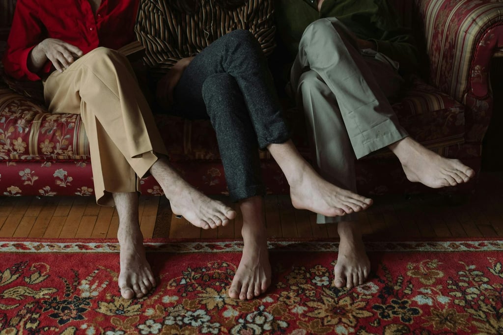 Three people sitting cross legged on a couch. If crossing your legs feels comfortable, there is little reason to treat it as dangerous. Picture: cottonbro studio/Pexels