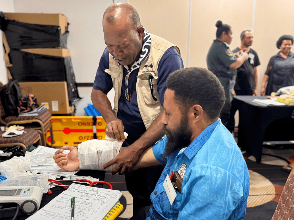 Two attendees immerse themselves in a medical training session.