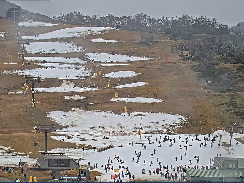 Image of the "front valley" view on the Perisher snow cam, captured at 1.45pm on 30 June 2026, showing a ski slope with isolated patches of snow.