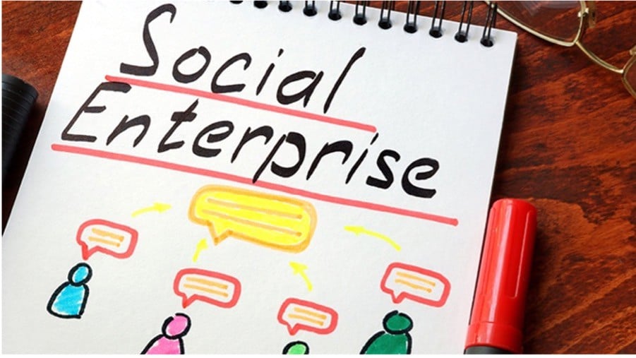 Notebook page with "Social Enterprise" written in bold, surrounded by colourful drawings of people and speech bubbles, giving a collaborative vibe.