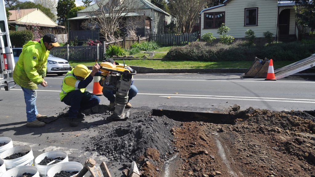 Photo of workers using sustainable materials in suburban road