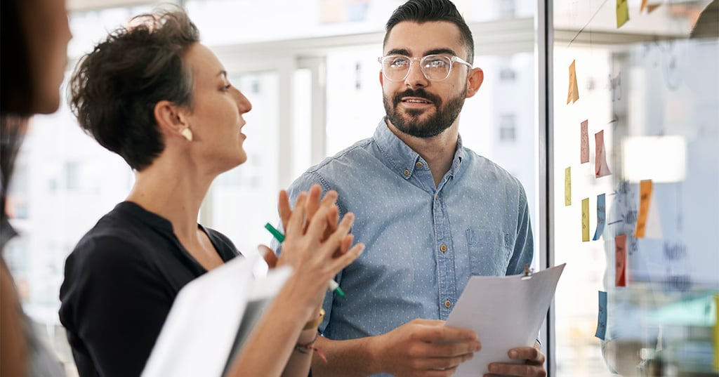 Professionals collaborating at a whiteboard
