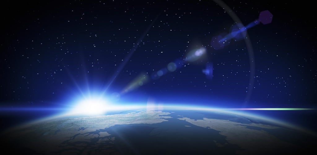 A view of Earth from space with the sun rising over the horizon. The scene is set against a starry sky, evoking a sense of awe and wonder.