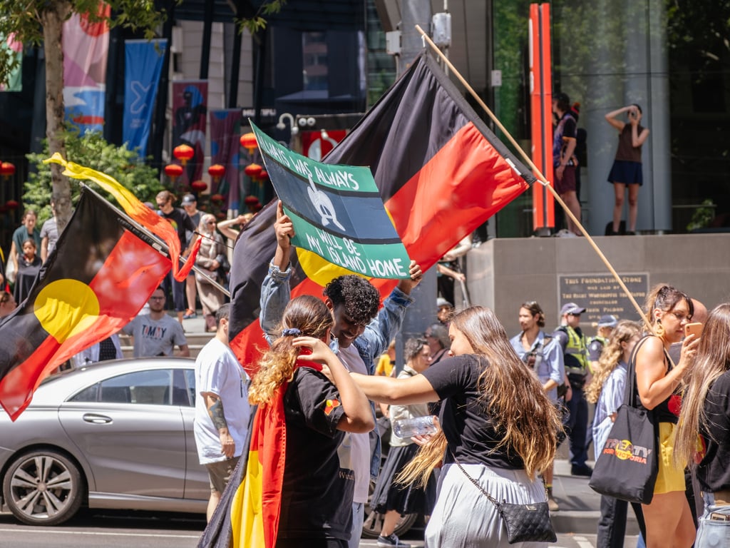 Image of a group of people with Aboriginal flags