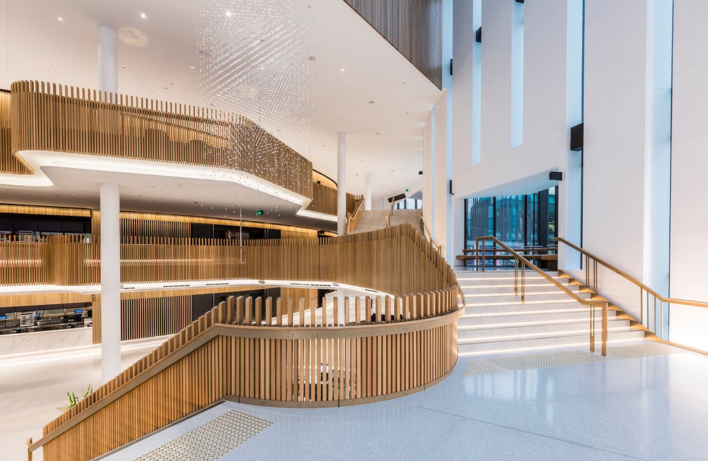 A light-flooded white and wooden stairwell.