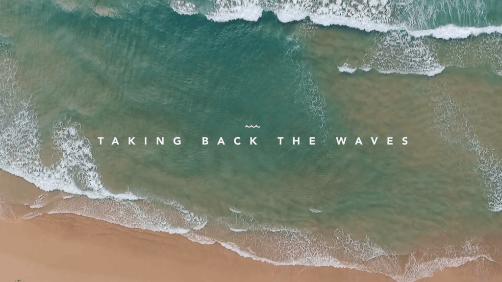 Aerial shot of a beach overlaid with the text: Taking back the waves.