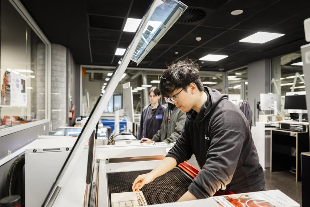 University student working with equipment in a creative makerspace