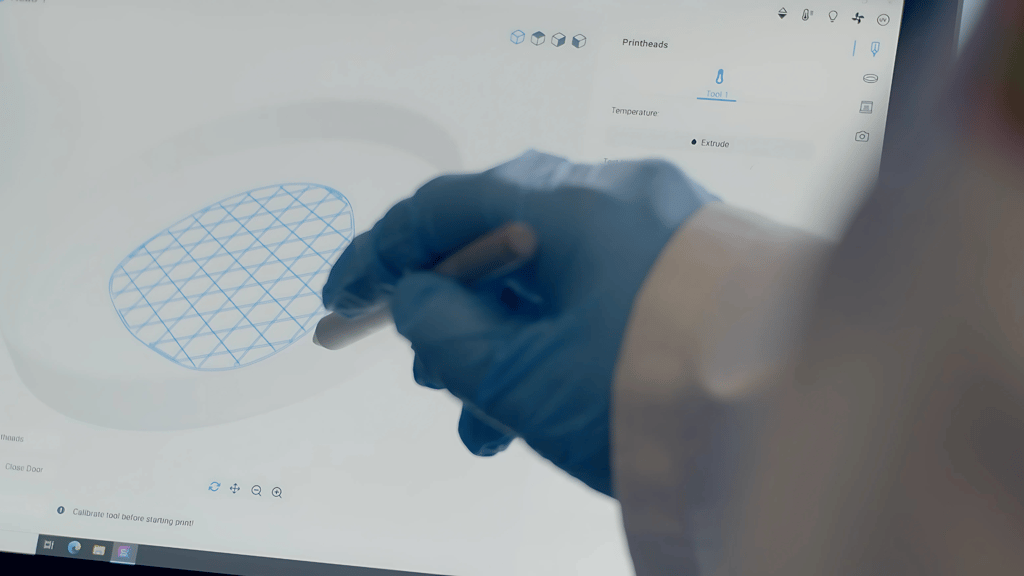 A scientist adjusts the design of a heart patch on screen