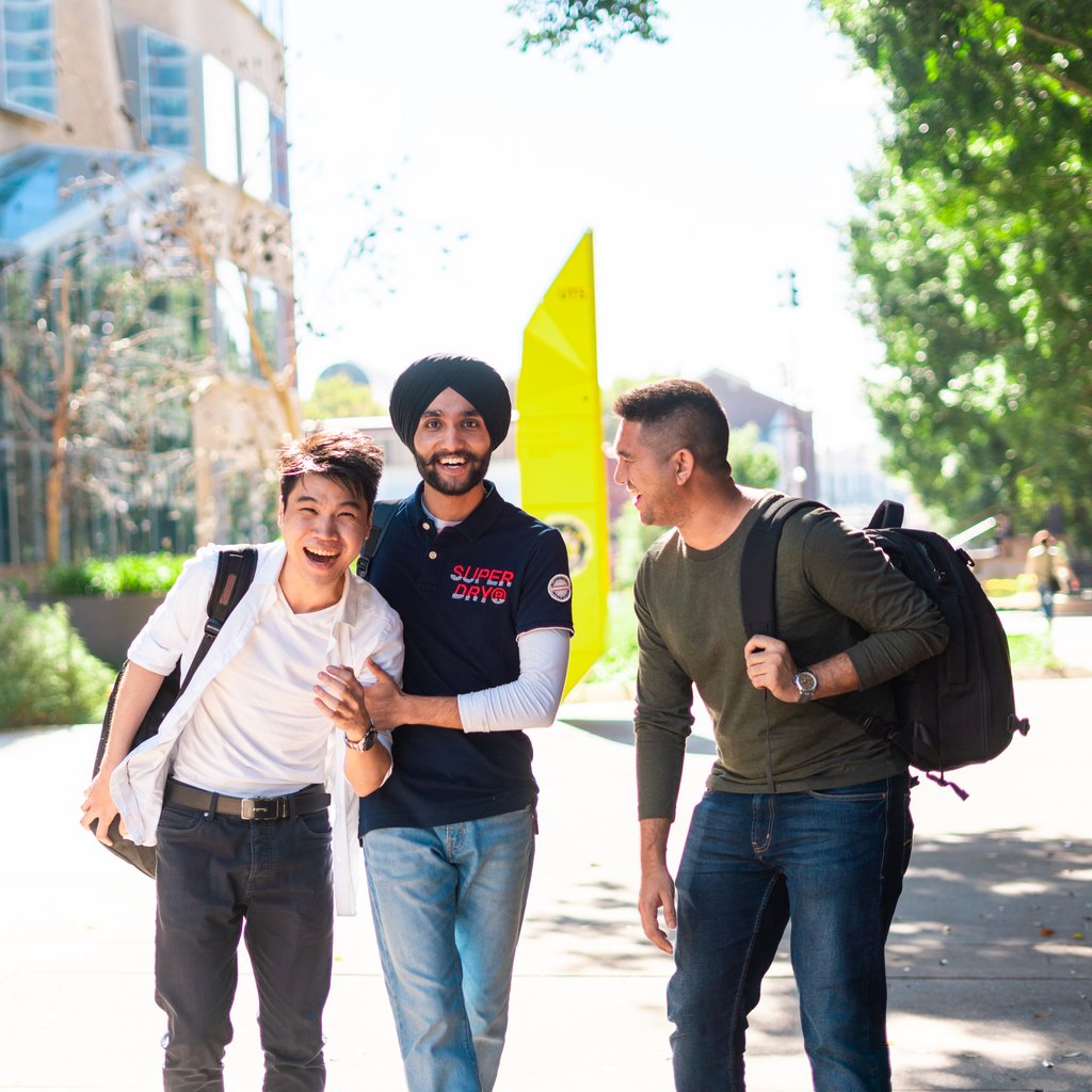 3 males students interacting on campus