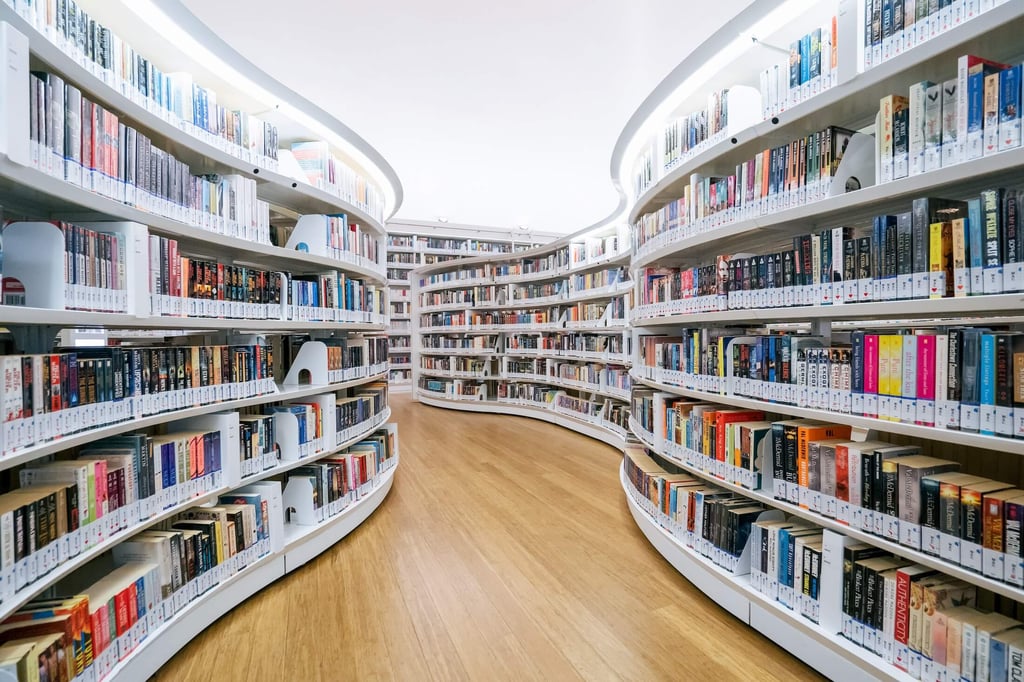White curved bookshelves in a library.