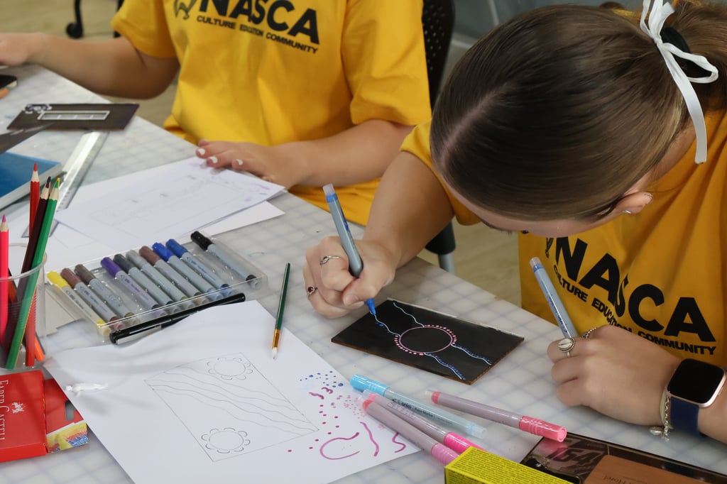 High school student making Indigenous artwork at the NASCA workshop