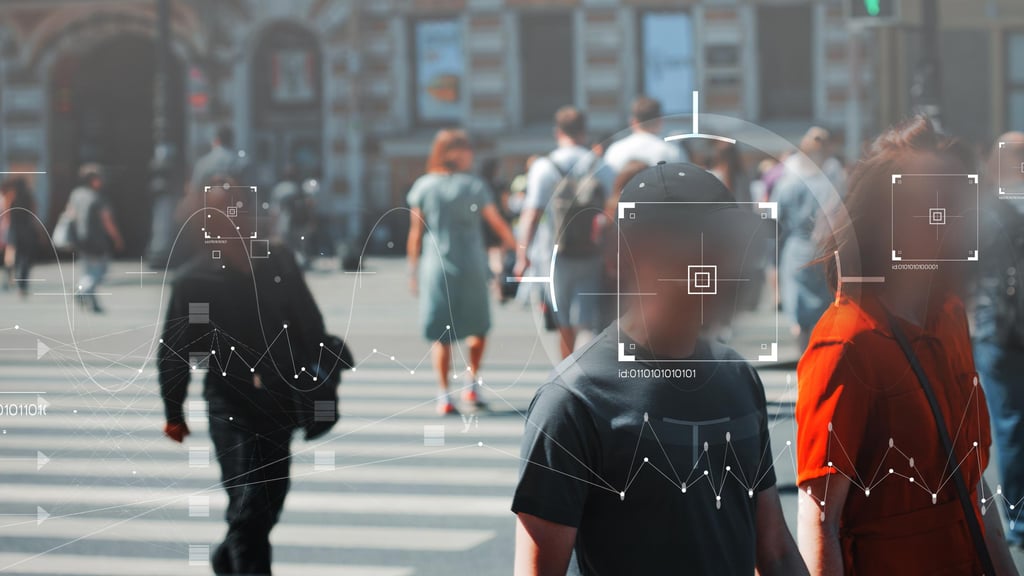 A busy city crosswalk with blurred pedestrians. Digital interface overlays with graphs and square focus points suggest data tracking, creating a futuristic tone.