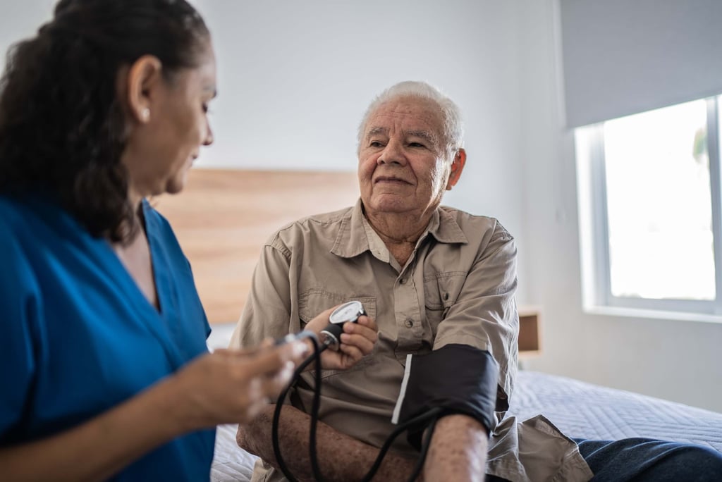 Elderly man having his blood pressure checked.