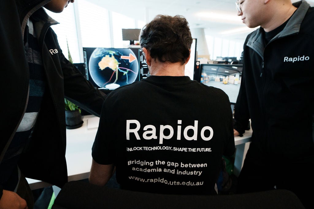 Three software engineers collaborating at a screen