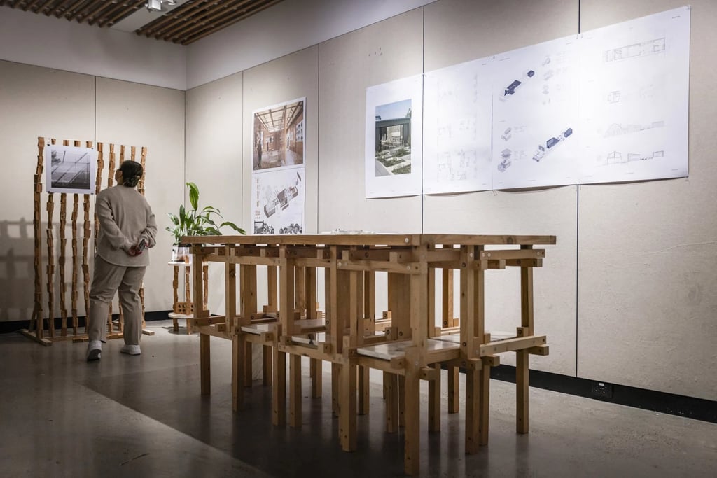 Person observing designs being showcased in a modern gallery space