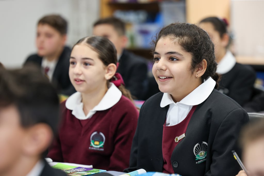 Two young female students sitting in a classroom