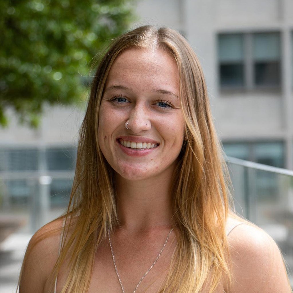 An image of a young blonde female smiling at the camera