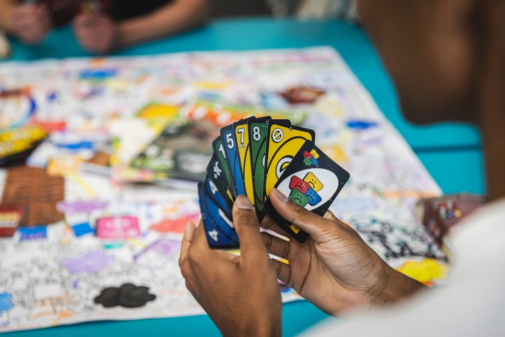 Student holding playing cards