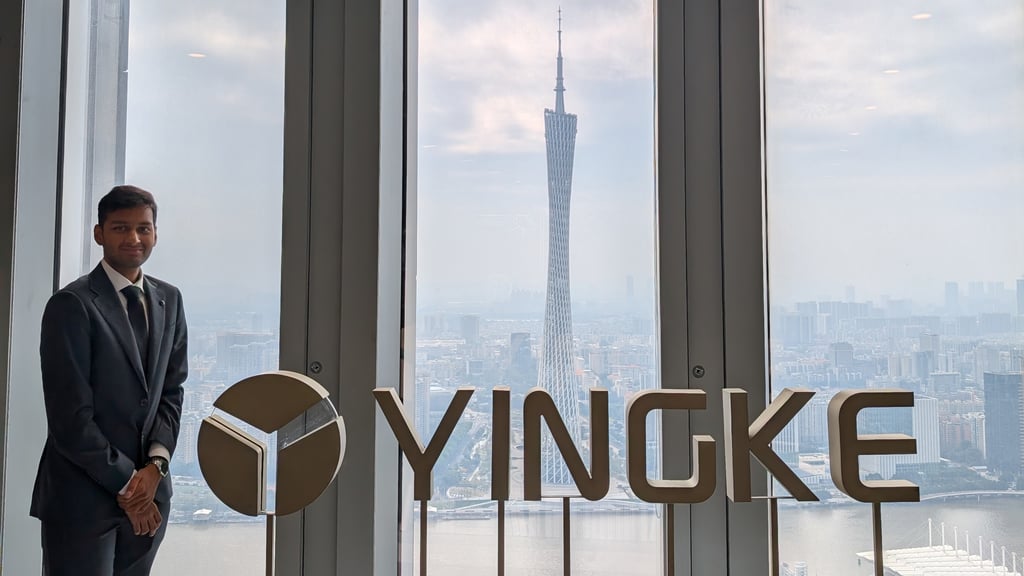 Sai visiting the Yingke Law Firm in Beijing. He stands in front of a window showing the city skyline.