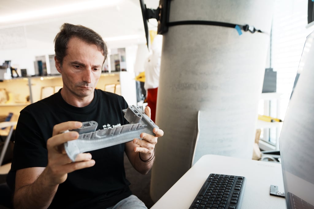 Software engineering inspecting a 3D-printed engineering component in a UTS Rapido workshop
