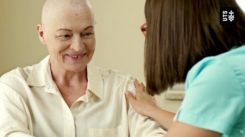A woman engages in conversation with a nurse in a medical setting.