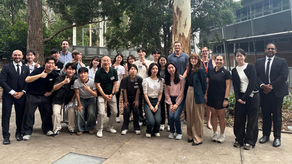 Preservice teachers in a group photo with Chatswood High School representatives outside the school