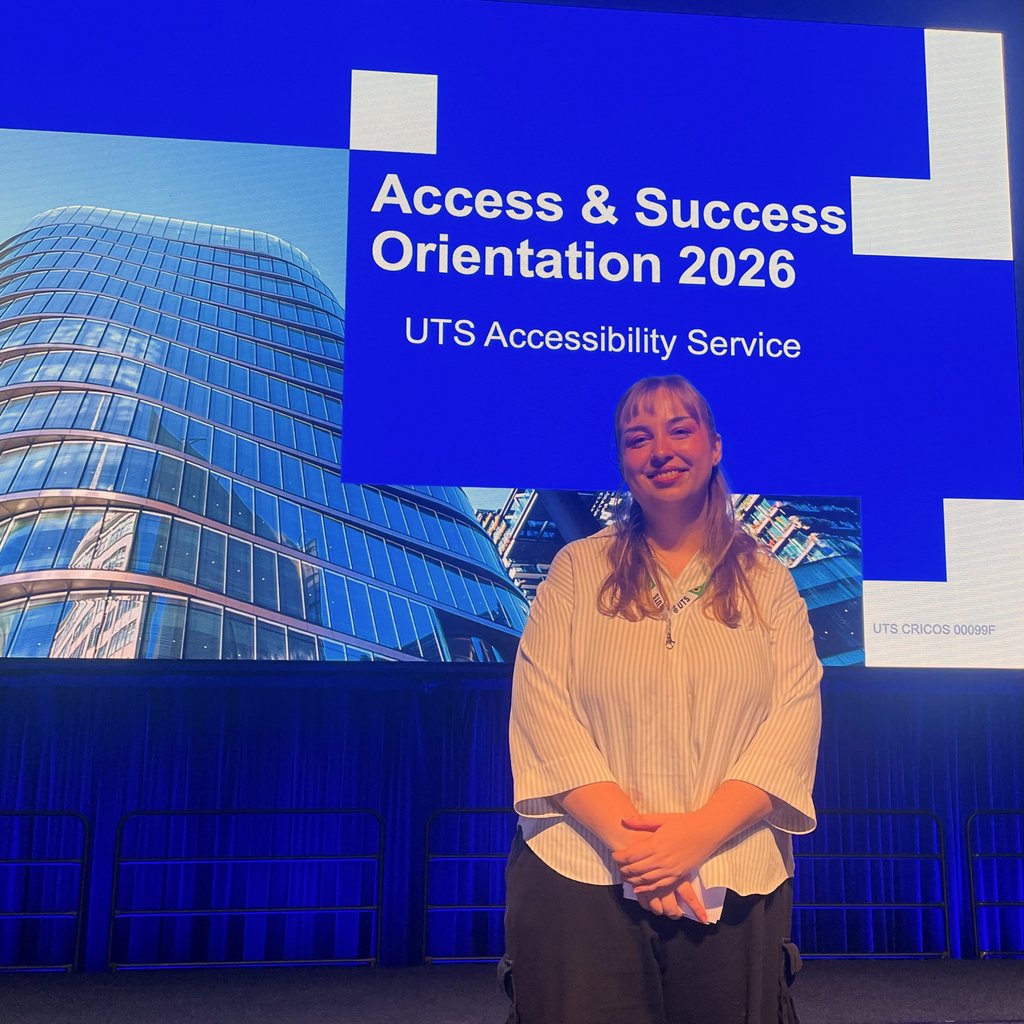 Frederikke (Freddy) Thorup in front of a sign that reads 'Access & Success Orientation 2026 UTS Accessibility Service'