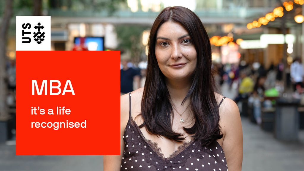 The words "MBA, it's a life recognised" are contained within red block graphic with the UTS logo. Alison Gibson stand to the right staring at the viewer with a brown dress and look of confidence.