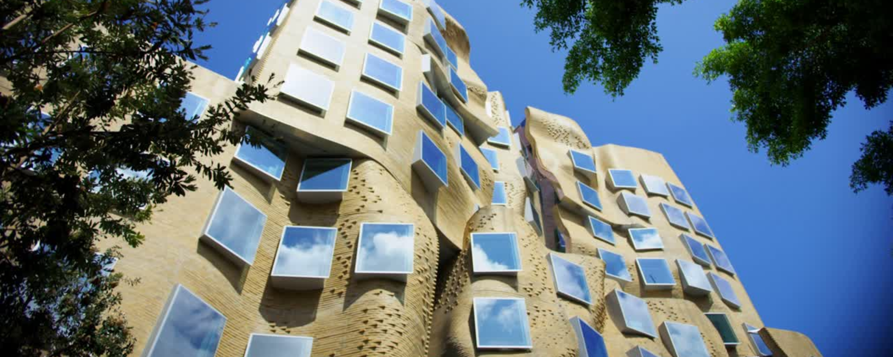 Building 8 reflecting clouds from its windows