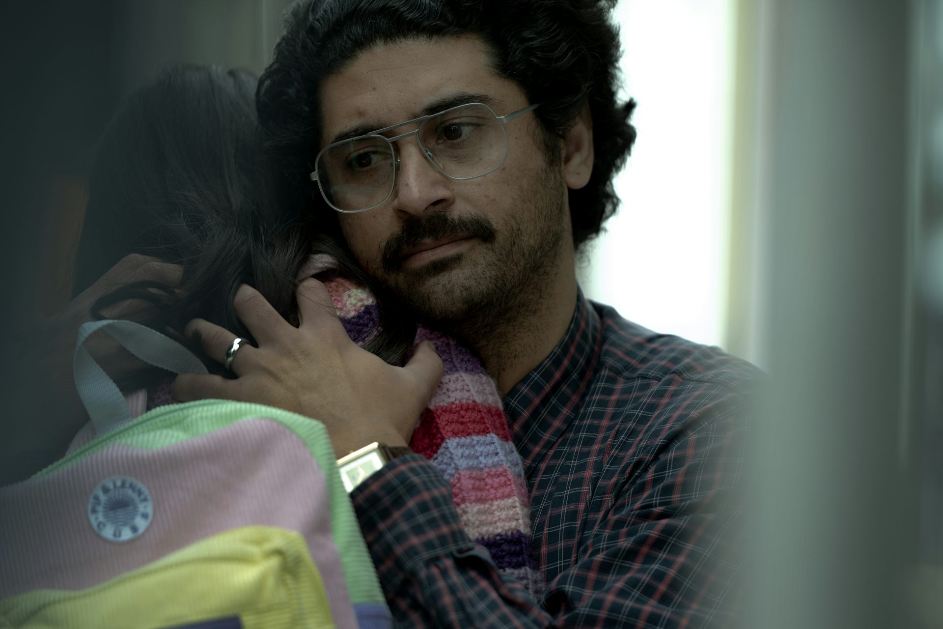 A man hugs his daughter.