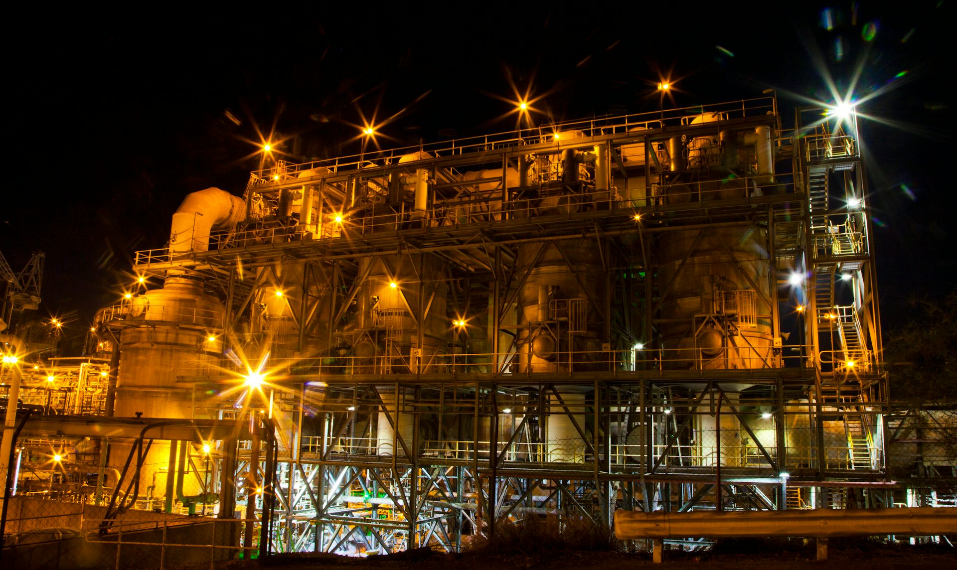 A mine processing plant and smelter lit up at night